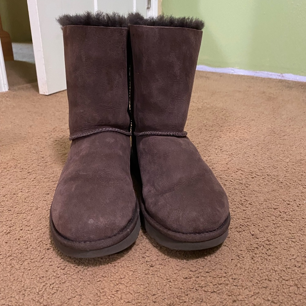 These are a pair of UGG Bailey bow II boots in dark brown